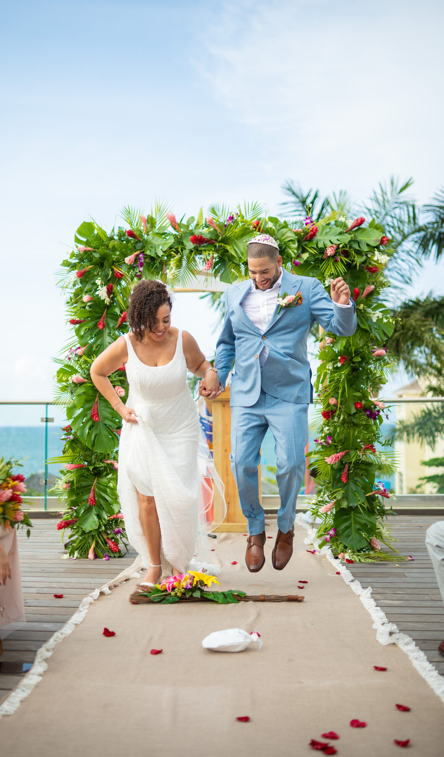 bride shina and groom andrew jumping the broom